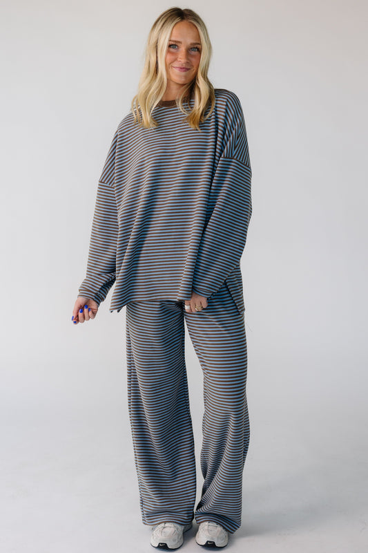 Young woman wearing a modest  blue & brown loose fitting lounge set with a crew neckline, long sleeves and long wide leg pants.
