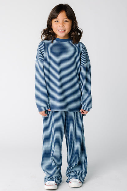 Girl wearing a loose fitting lounge set with long sleeves with wide long pants