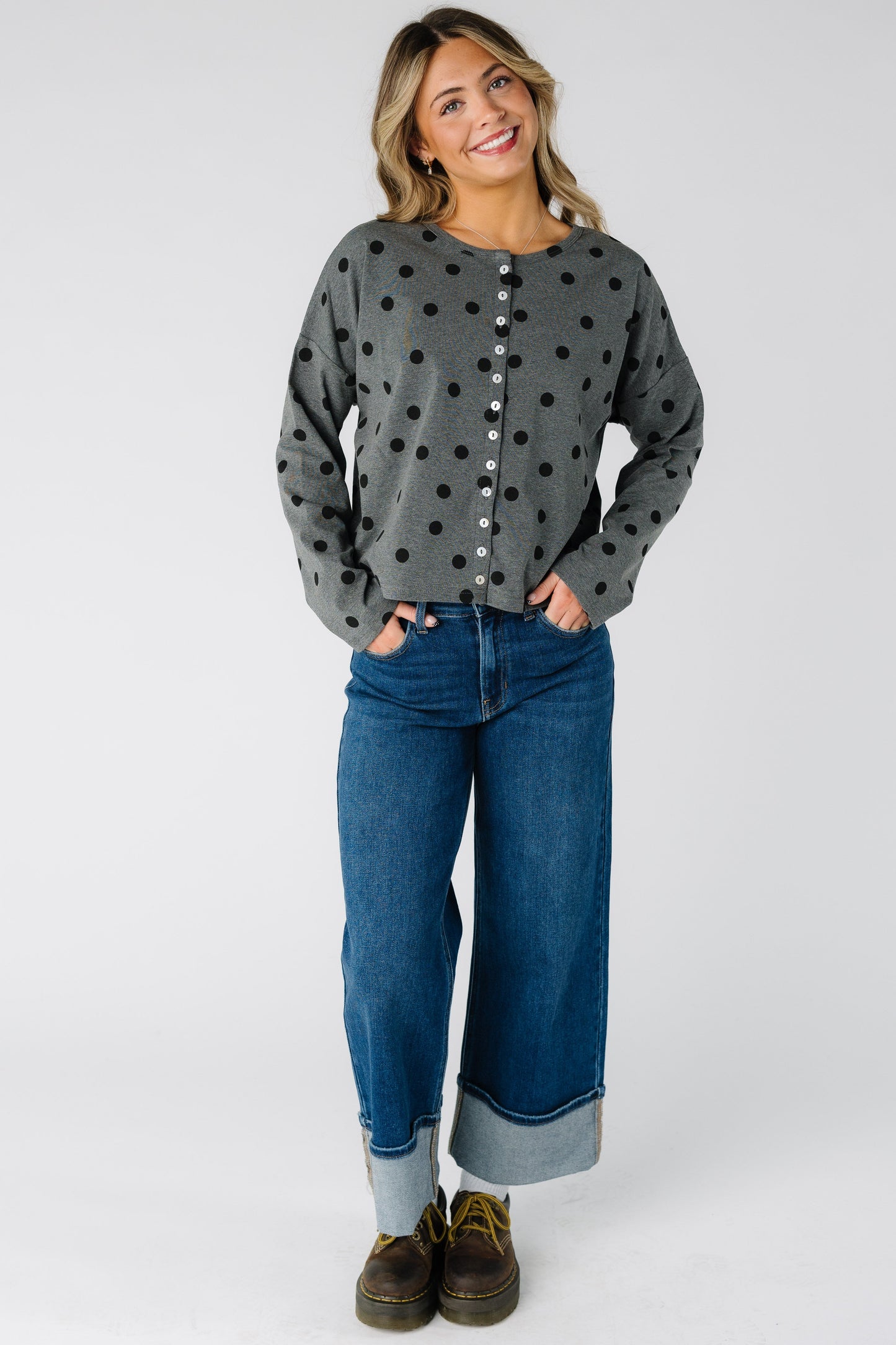 Woman wearing a modest grey cardigan with a round neckline and long sleeves