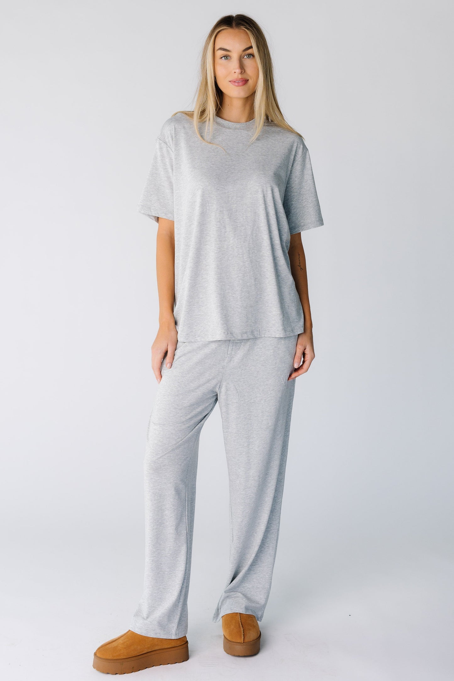 Woman wearing a modest lounge set with a round neckline and short sleeves with full length bottoms