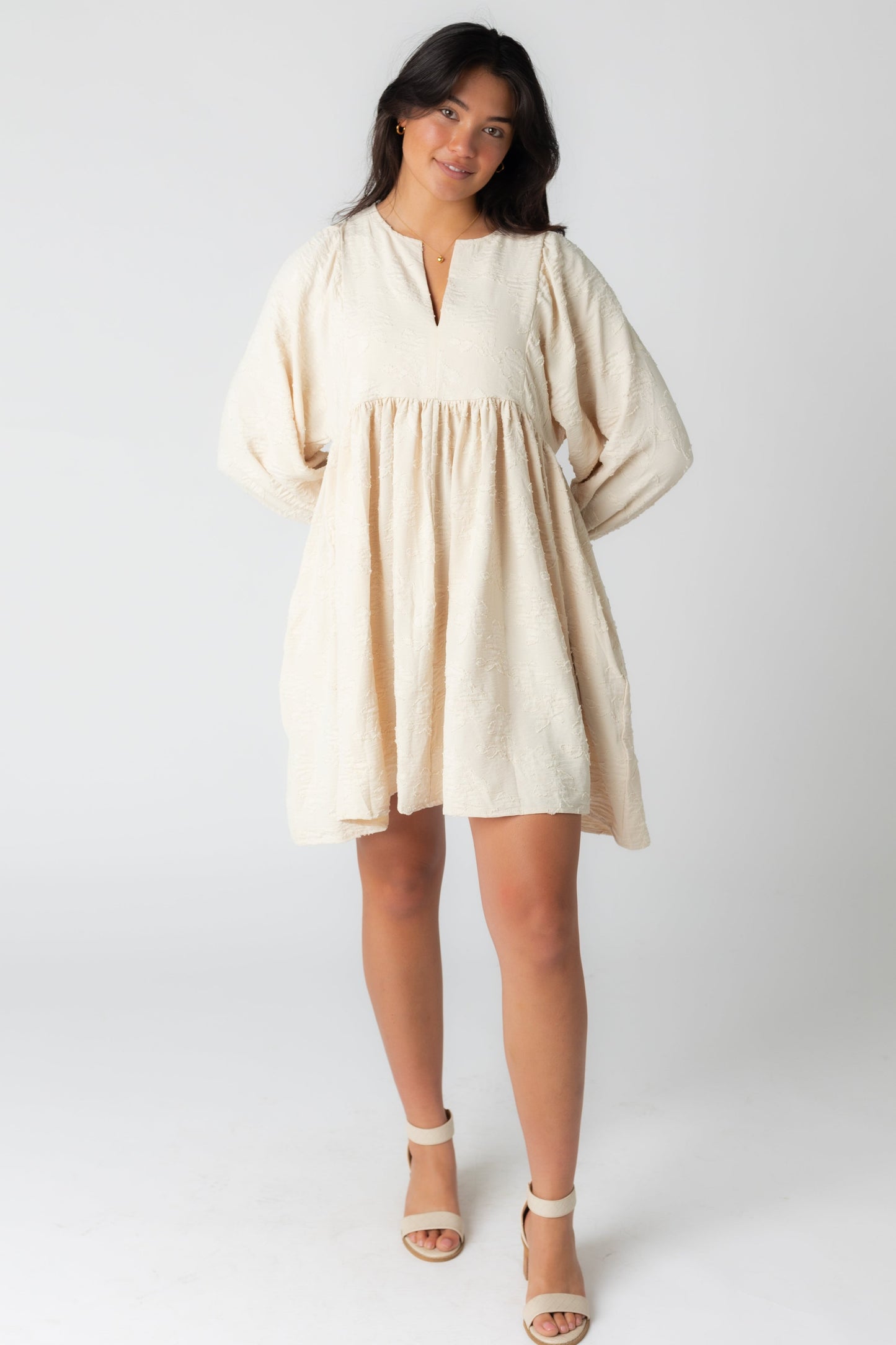 Cream jacquard mini with notched neckline and long sleeves