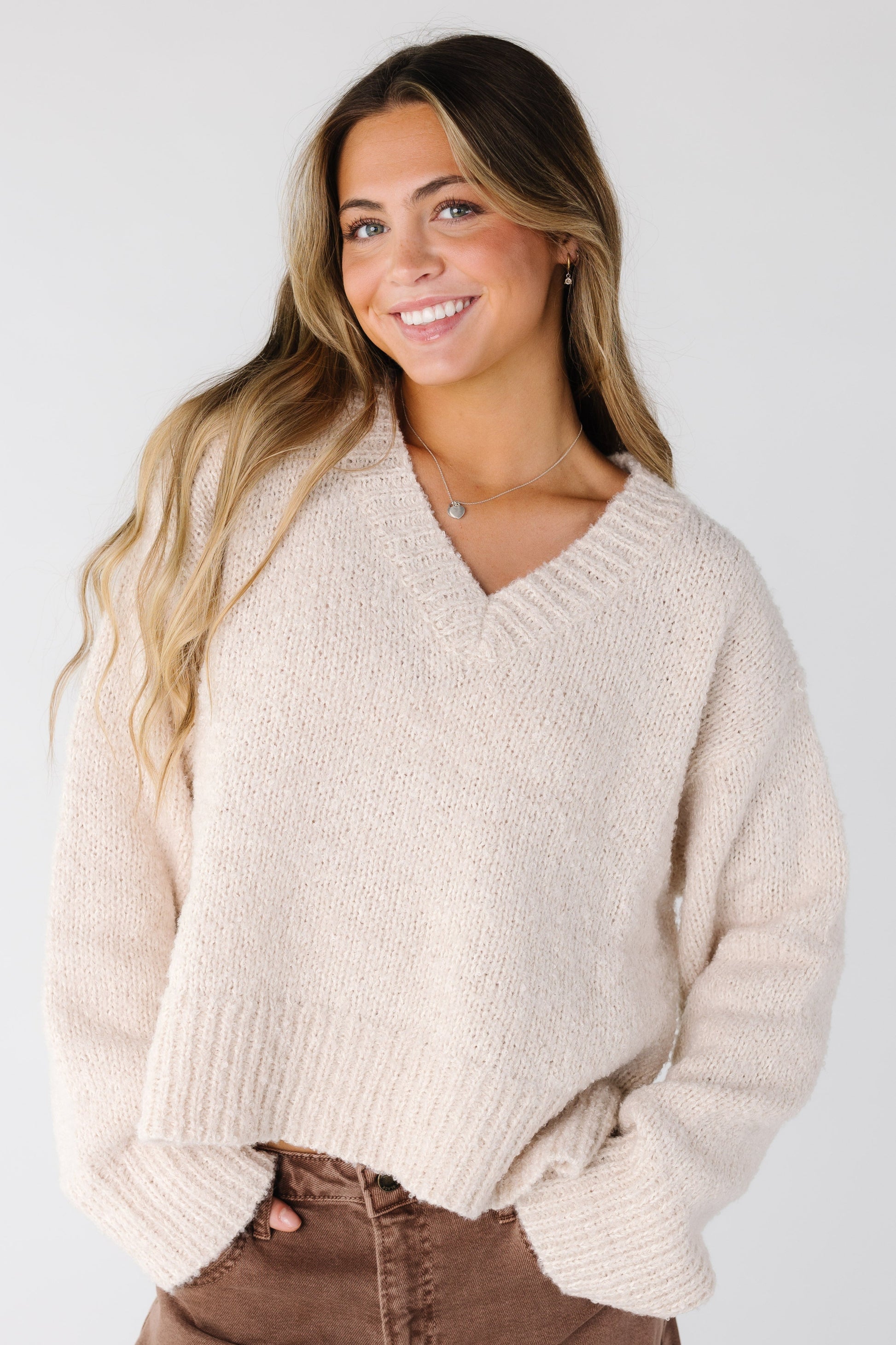 Modest oversized cream sweater with v-neckline and long sleeves