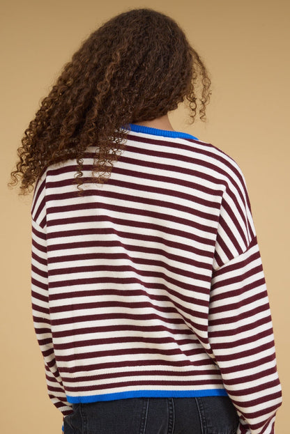Back view of a teenage girl wearing a loose fitting stripe top in burgundy & cream.