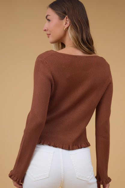 Back view of a woman wearing a brown rib knit top with ruffle cuffs and waist.