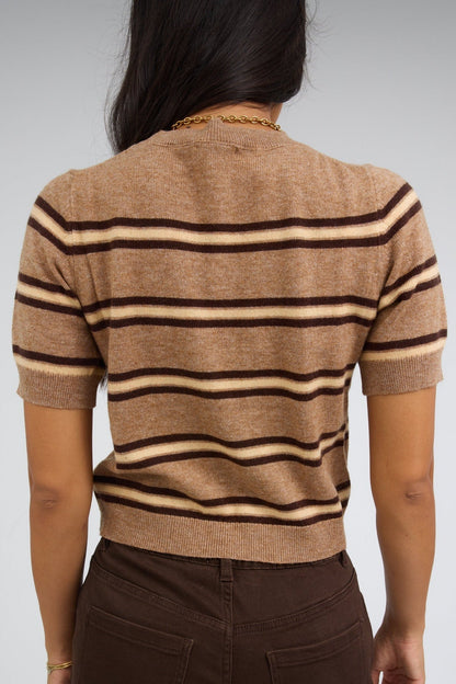 Back view of a woman wearing a latte light brown stripe sweater with short sleeves.