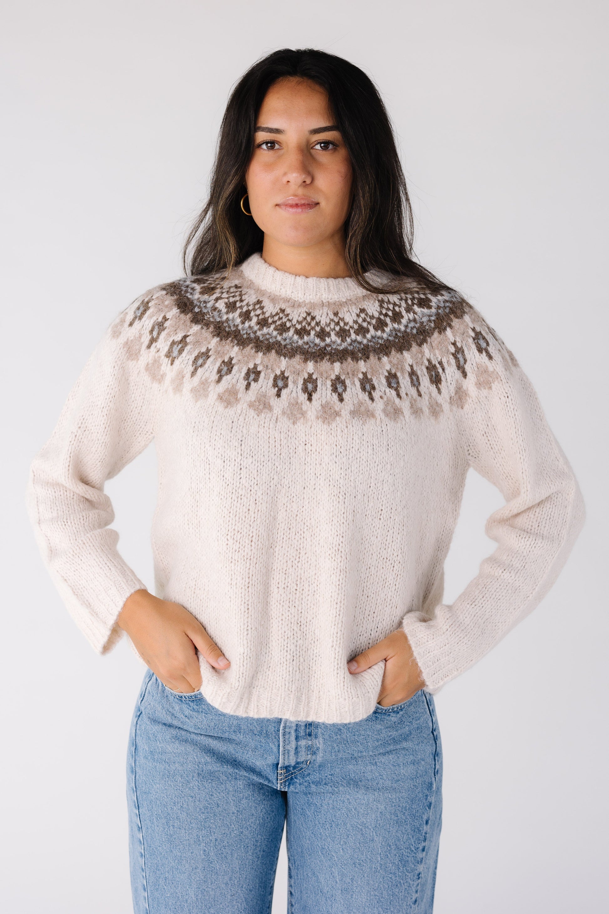Woman wearing a ivory Fair Isle pullover sweater