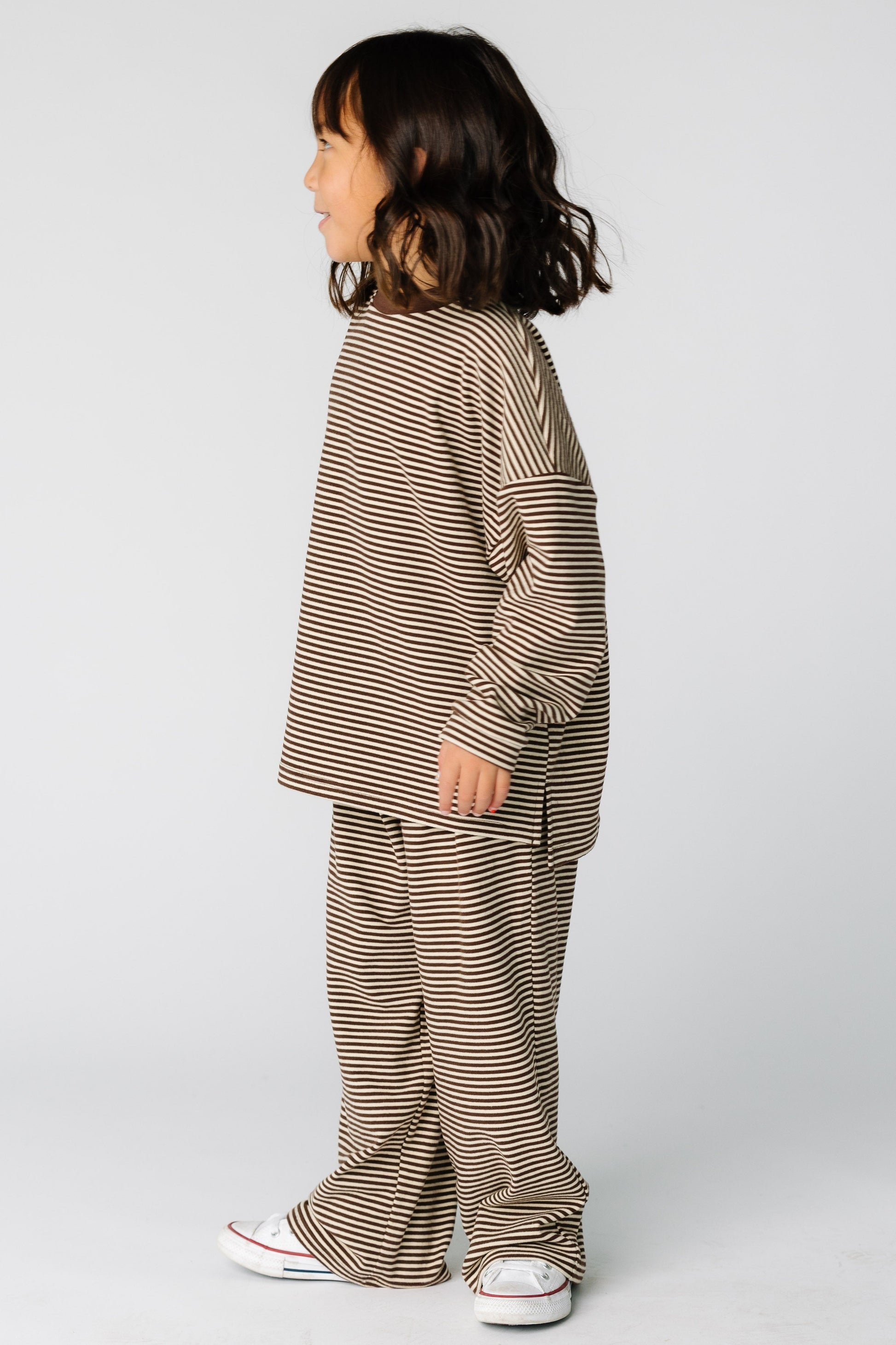 Girl wearing a modest 2 piece lounge set in brown