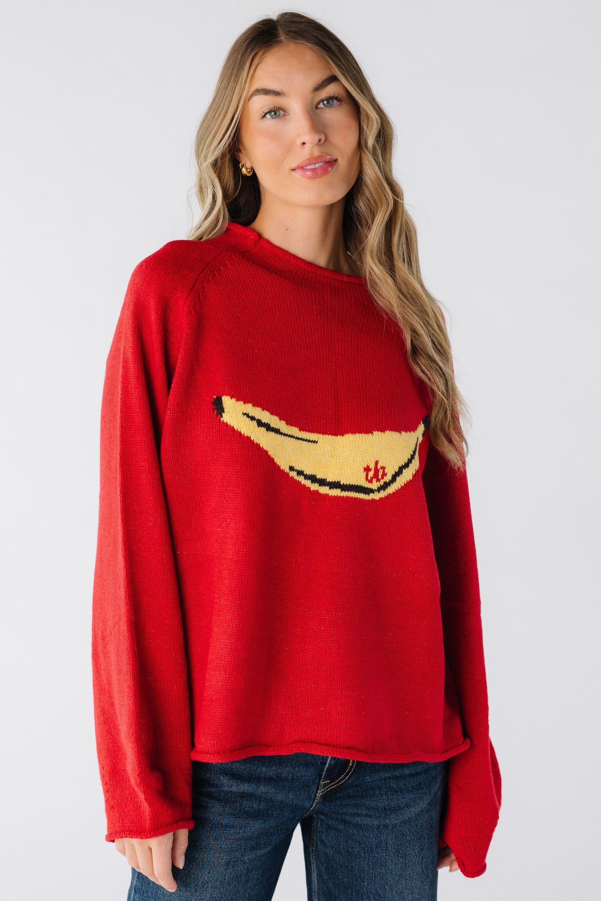 Modest women's red sweater with high rolled neckline and long sleeves with rolled cuffs and large banana graphic