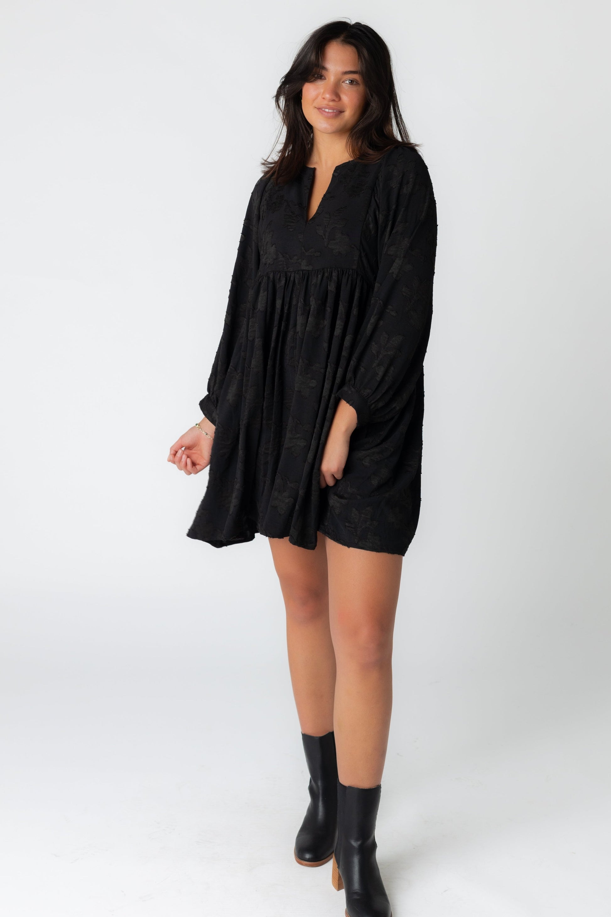 Black jacquard mini dress with notched neckline and long sleeves