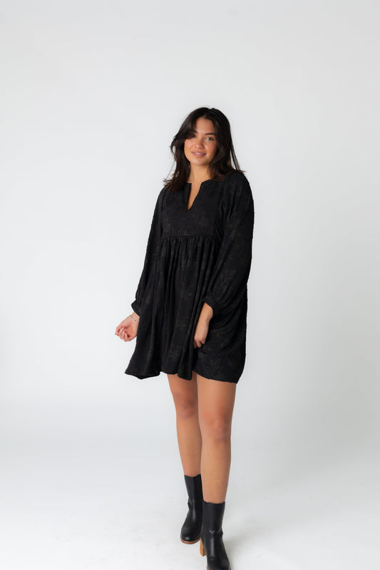 Black jacquard mini dress with notched neckline and long sleeves