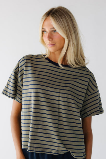 Young woman wearing a modest olive & navy stripe short sleeve tee.