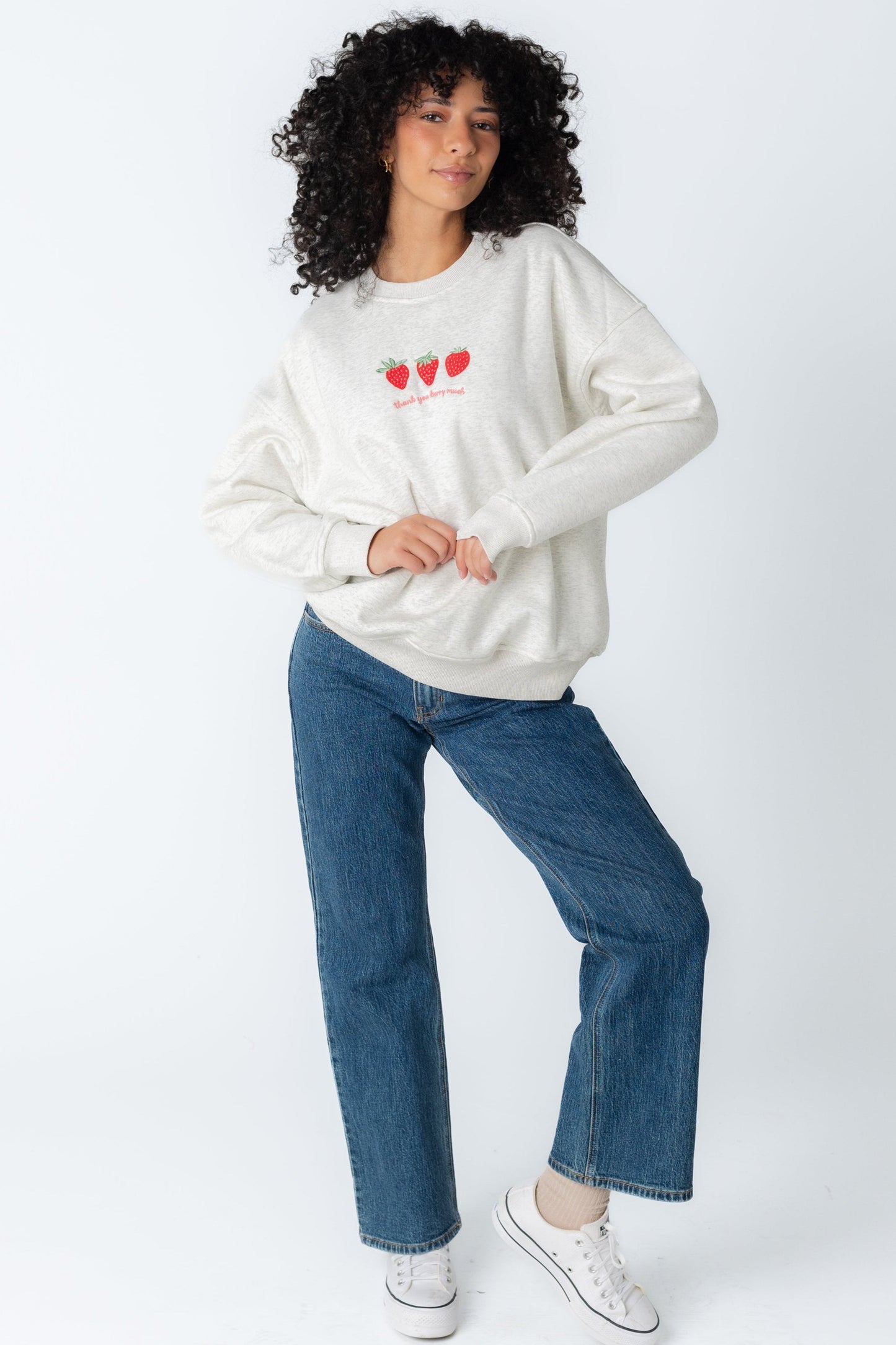 Long sleeve white sweatshirt with embroidered strawberry graphic