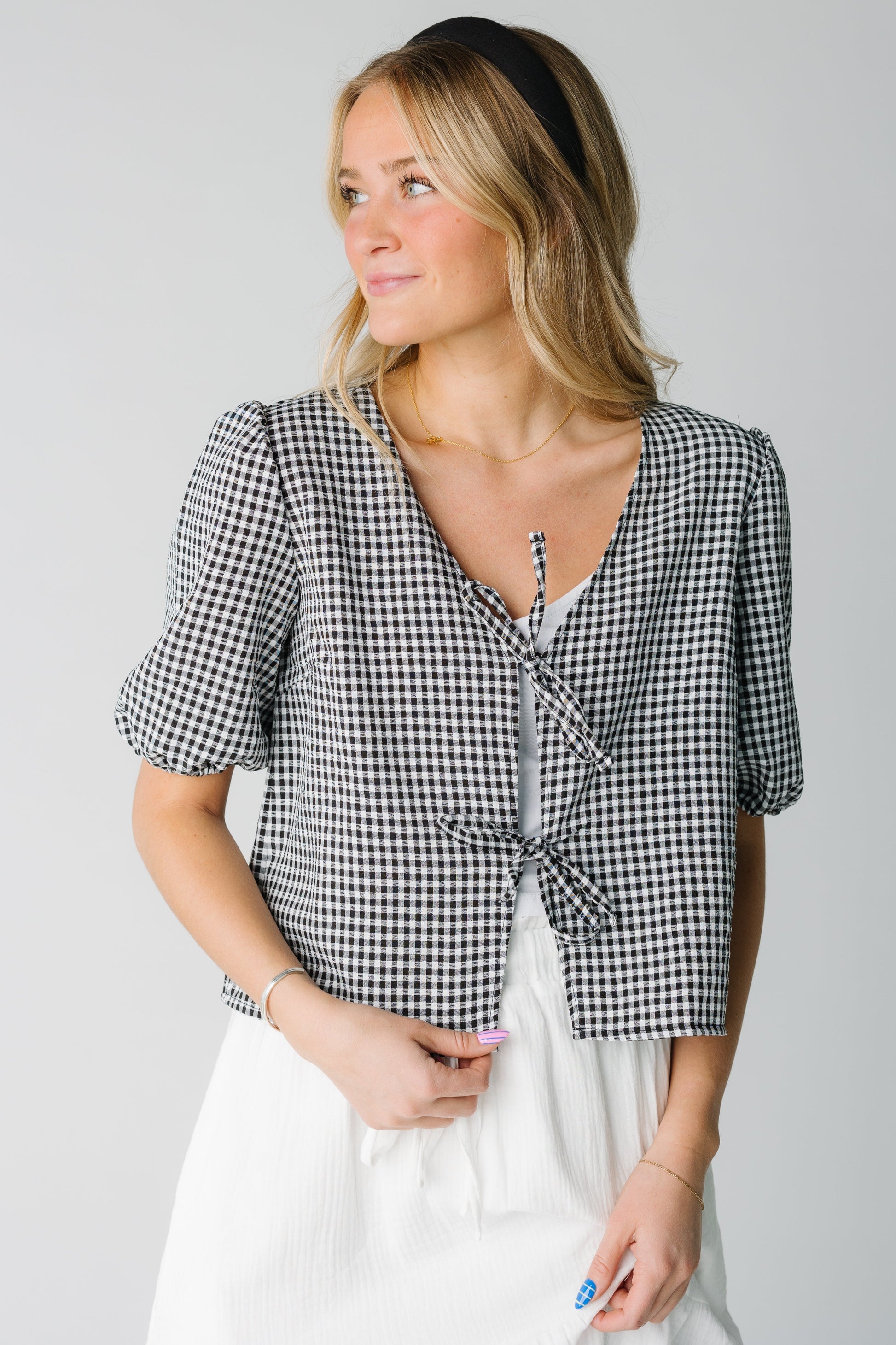 Black and white gingham open top with 2 tie closure with V-neckline and short puff sleeves