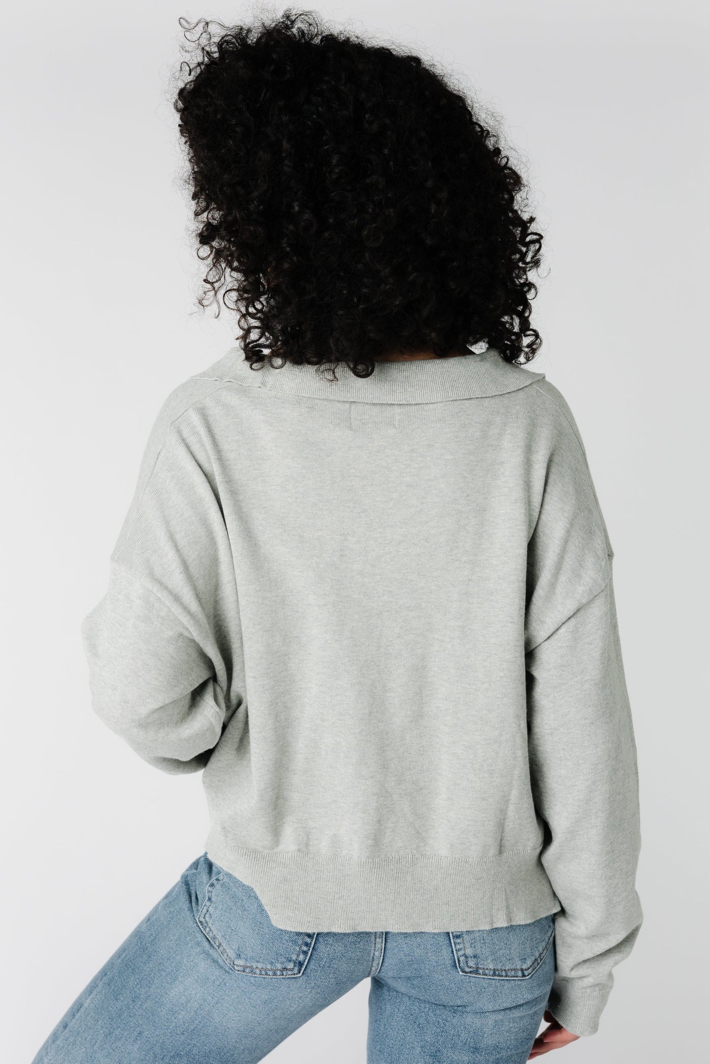 Back view of light grey loose fitting sweater