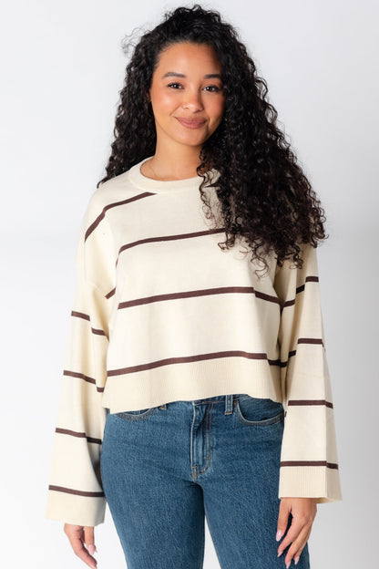 Cream sweater with crew neckline and wide loose sleeves