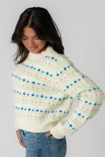 Side view of cream sweater with multicolor patterned sweater