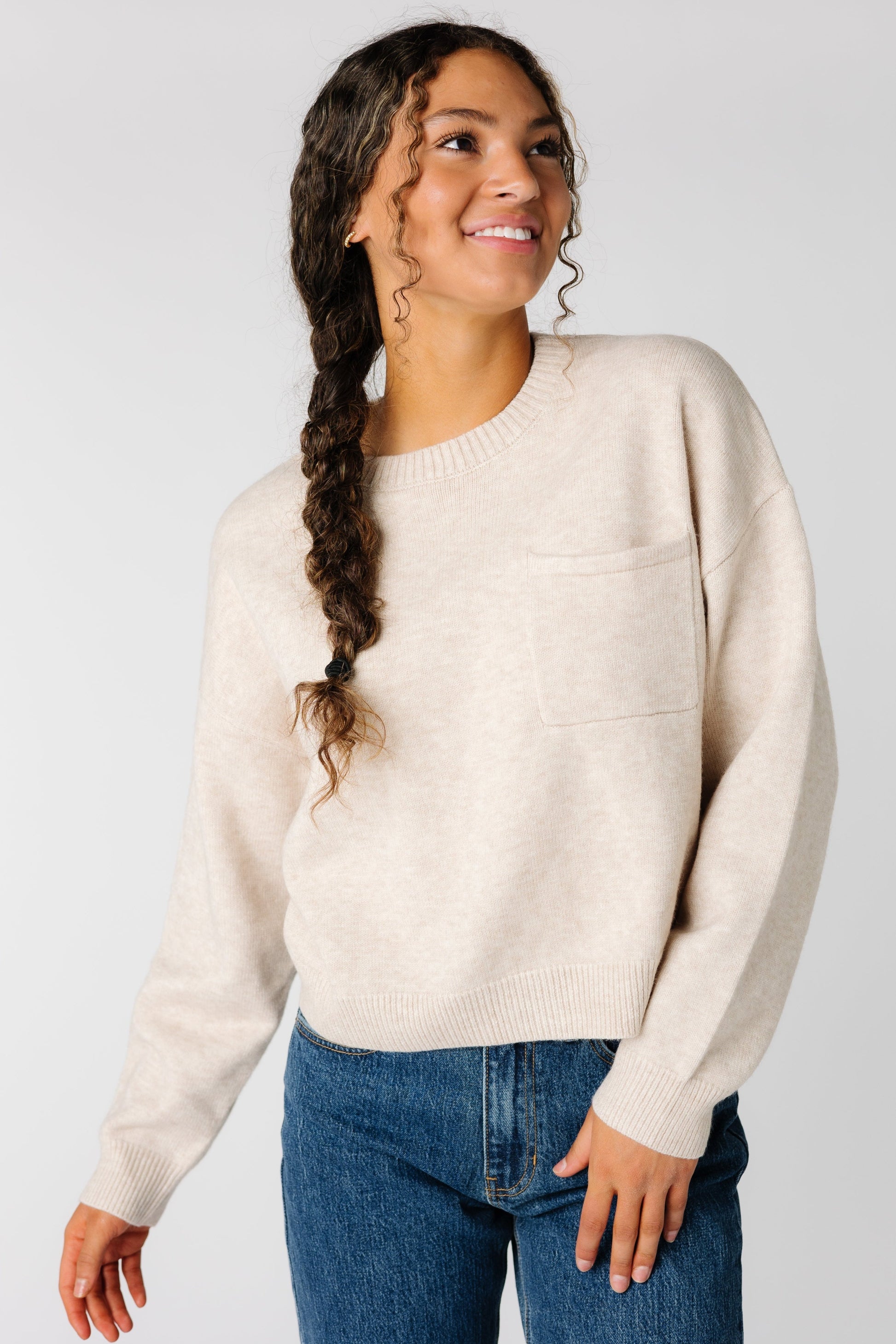 Waist length pullover sweater with single pocket