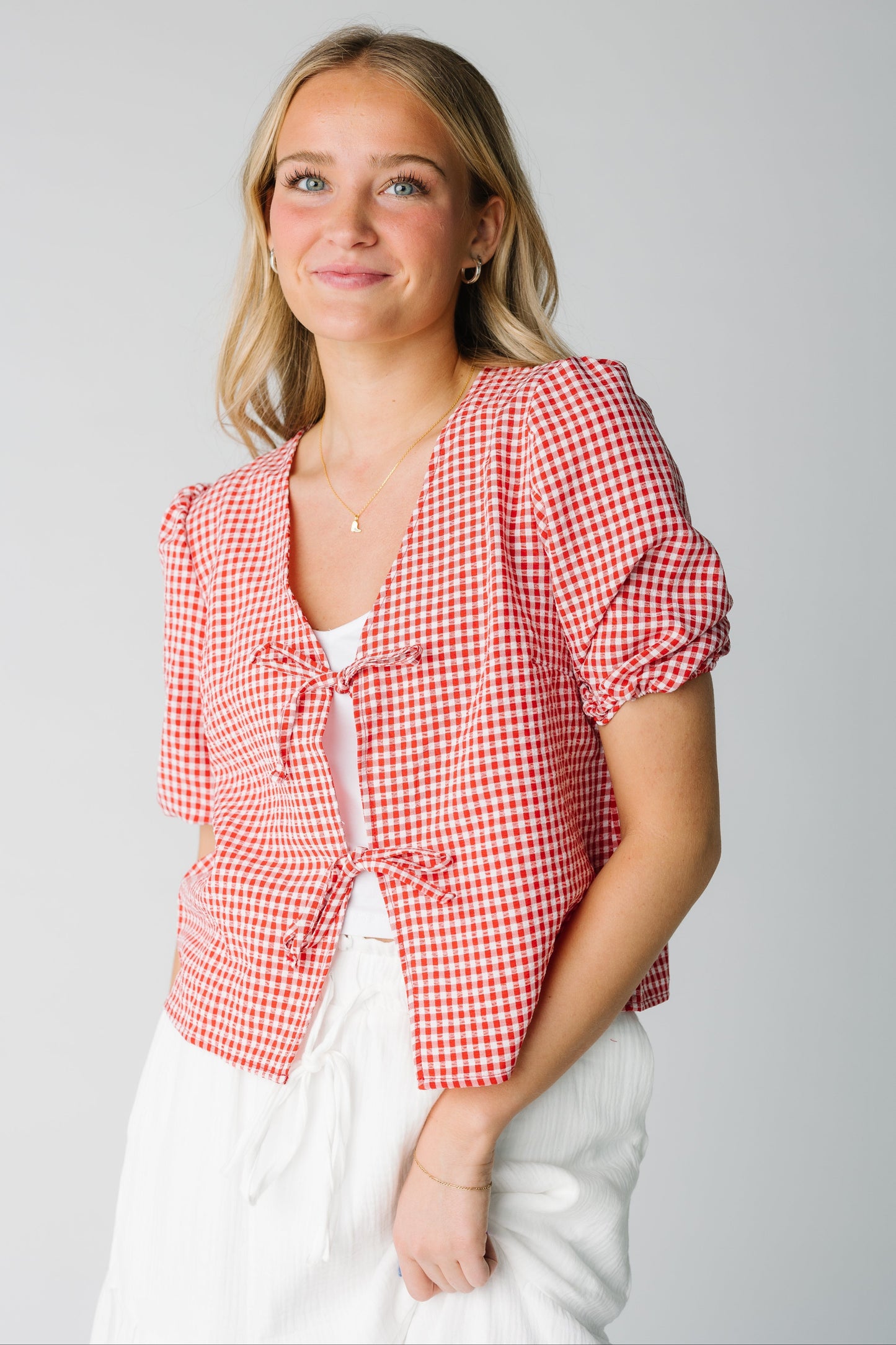 Red and white gingham open cardigan with 2 ties and short puff sleeves