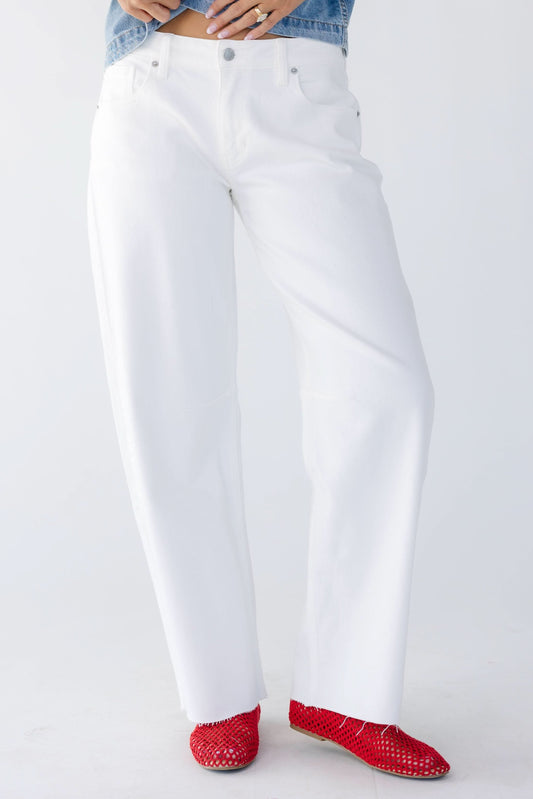 Young women wearing modest white barrel jeans with wide cut legs and scissor cut hems.