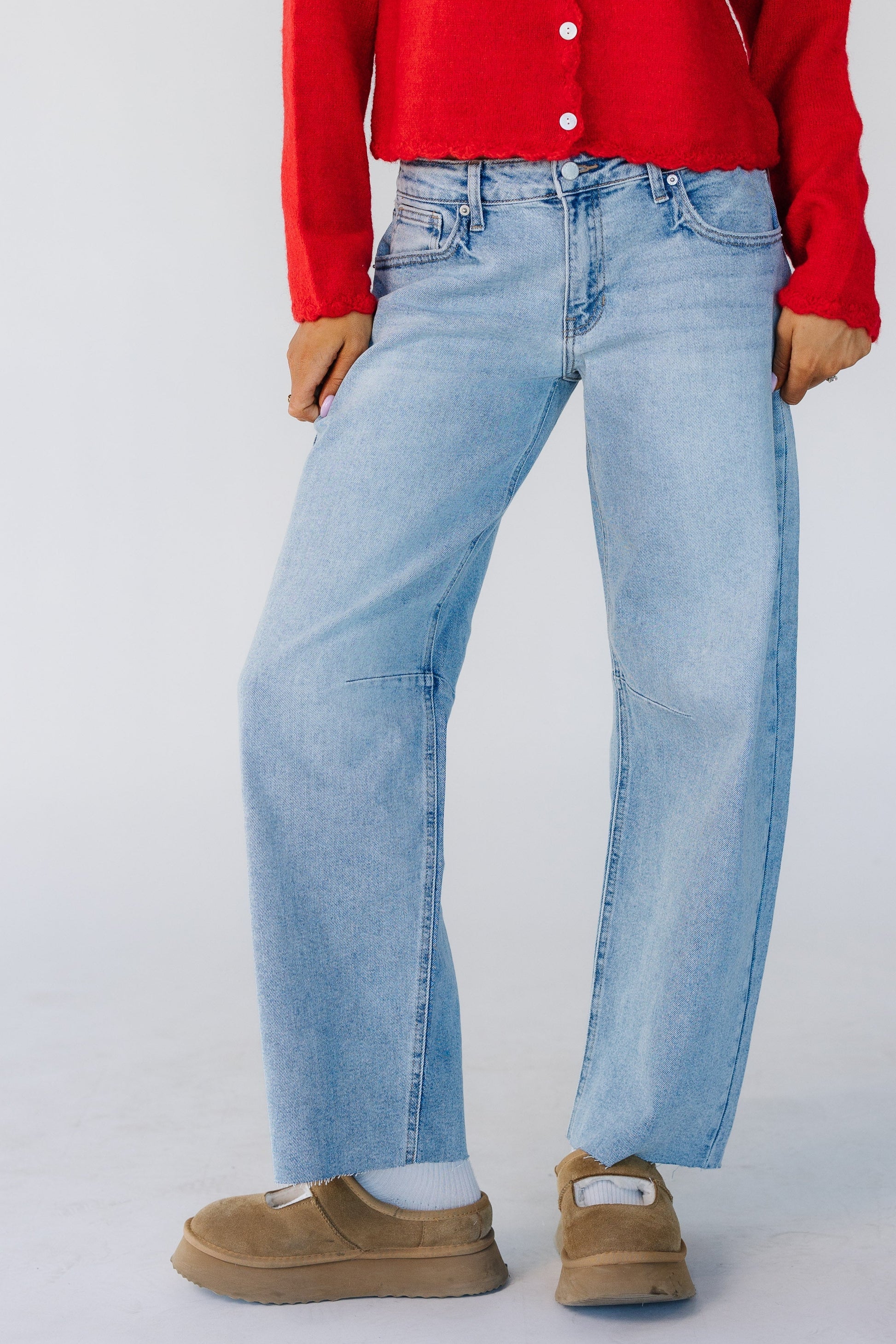 Woman wearing a modest pair of light denim barrel jeans.