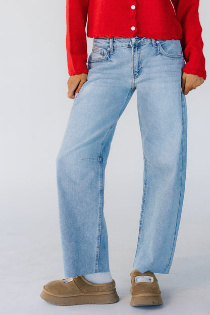 Woman wearing a modest pair of light denim barrel jeans.