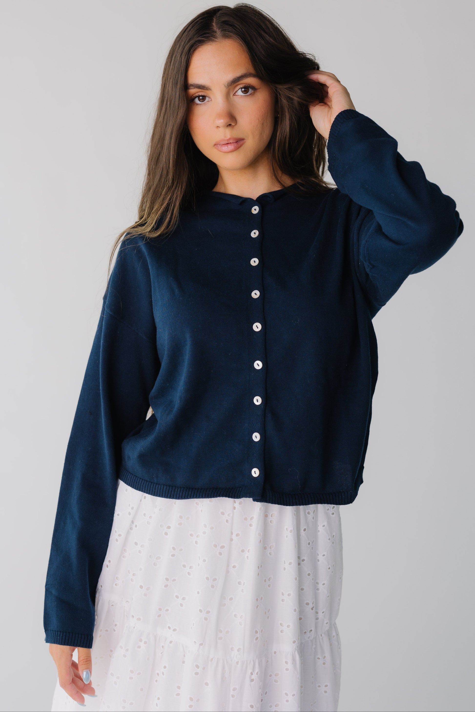 Women wearing dark navy long sleeve button down cardigan