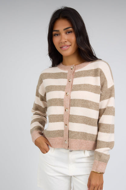 Young woman wearing a modest cardigan in taupe & cream with long sleeves.