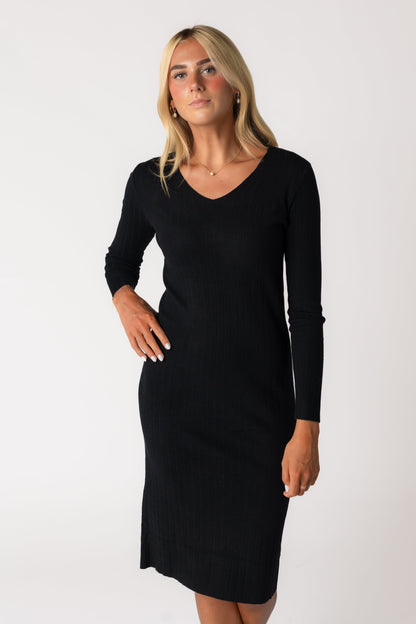 Close view of black ribbed sweater dress with long sleeves and V-neckline