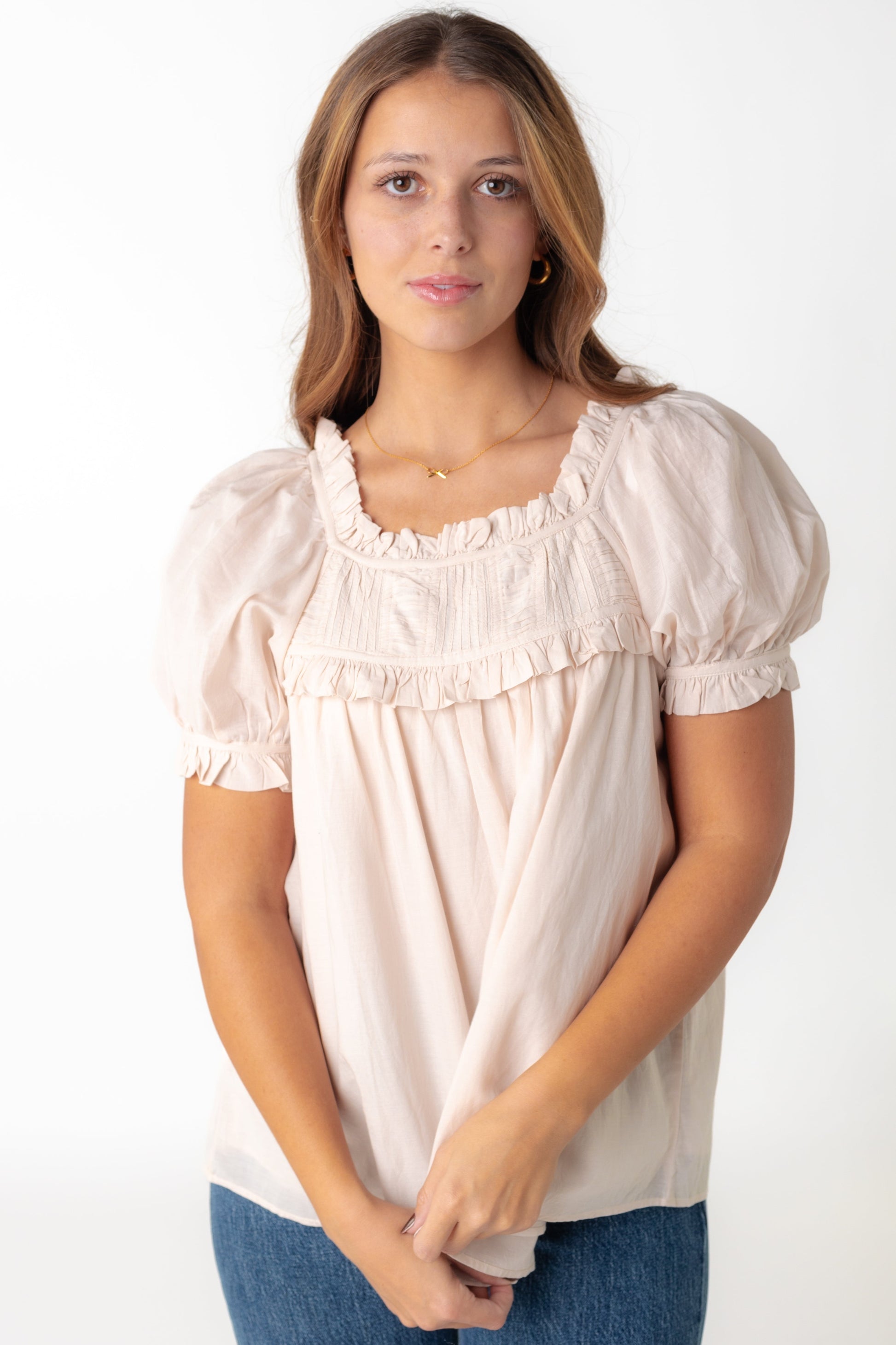 Modest beige top with ruffled neckline and short puff sleeves