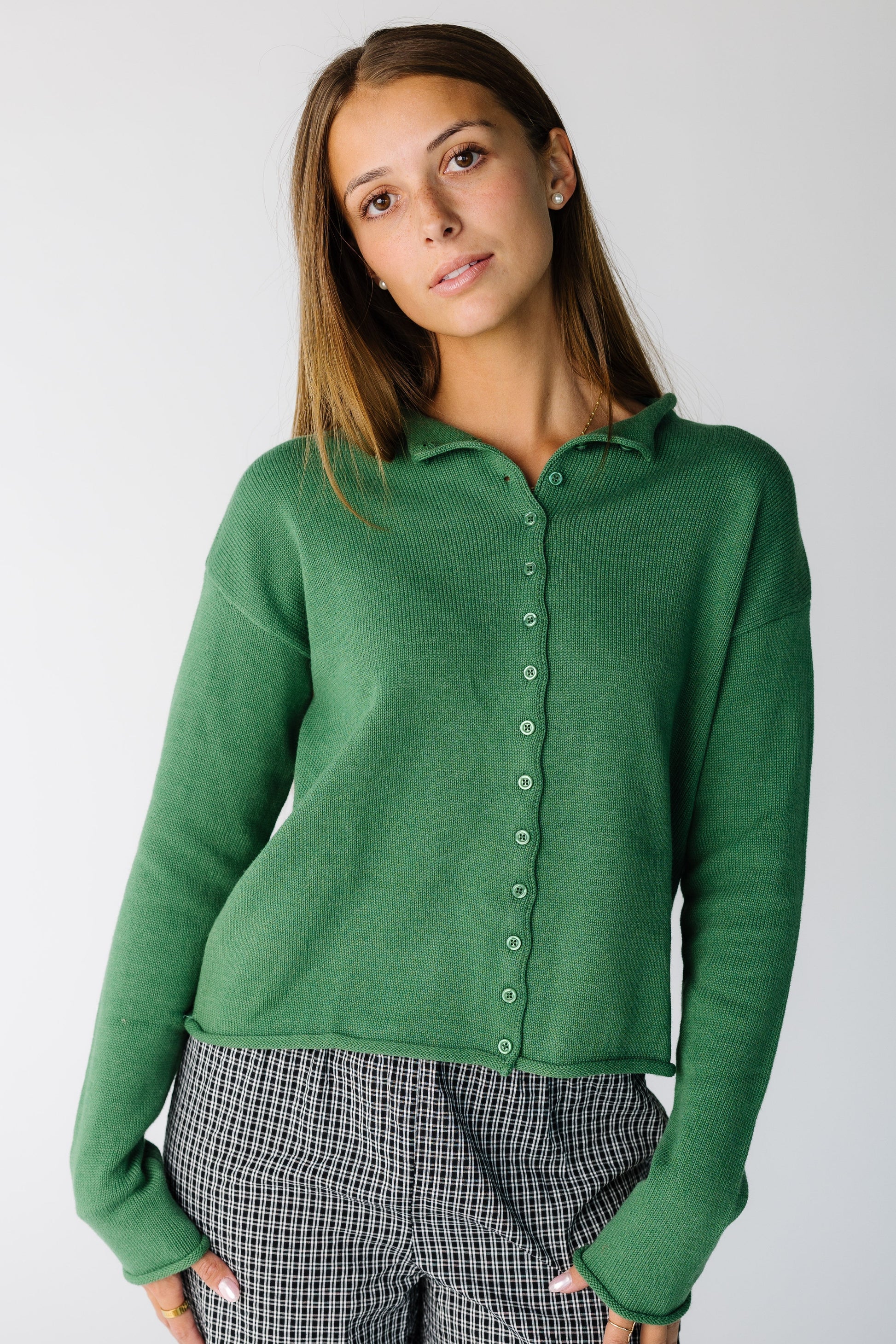 Woman wearing a modest long sleeve button cardigan with a collar and long sleeves