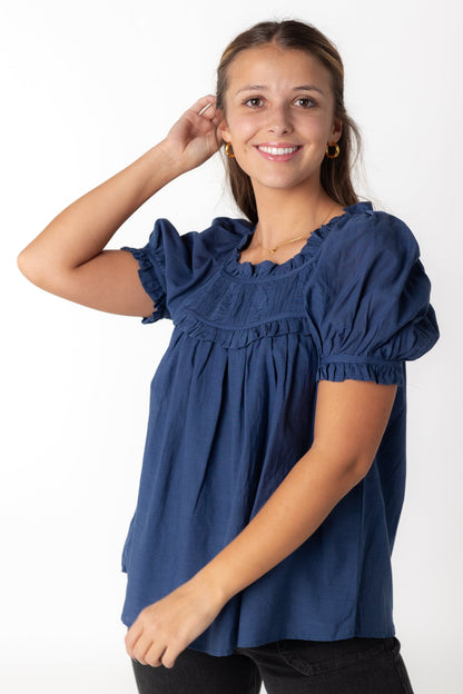 Blue scoop neck top with short puff sleeves ruffles and pleated yoke
