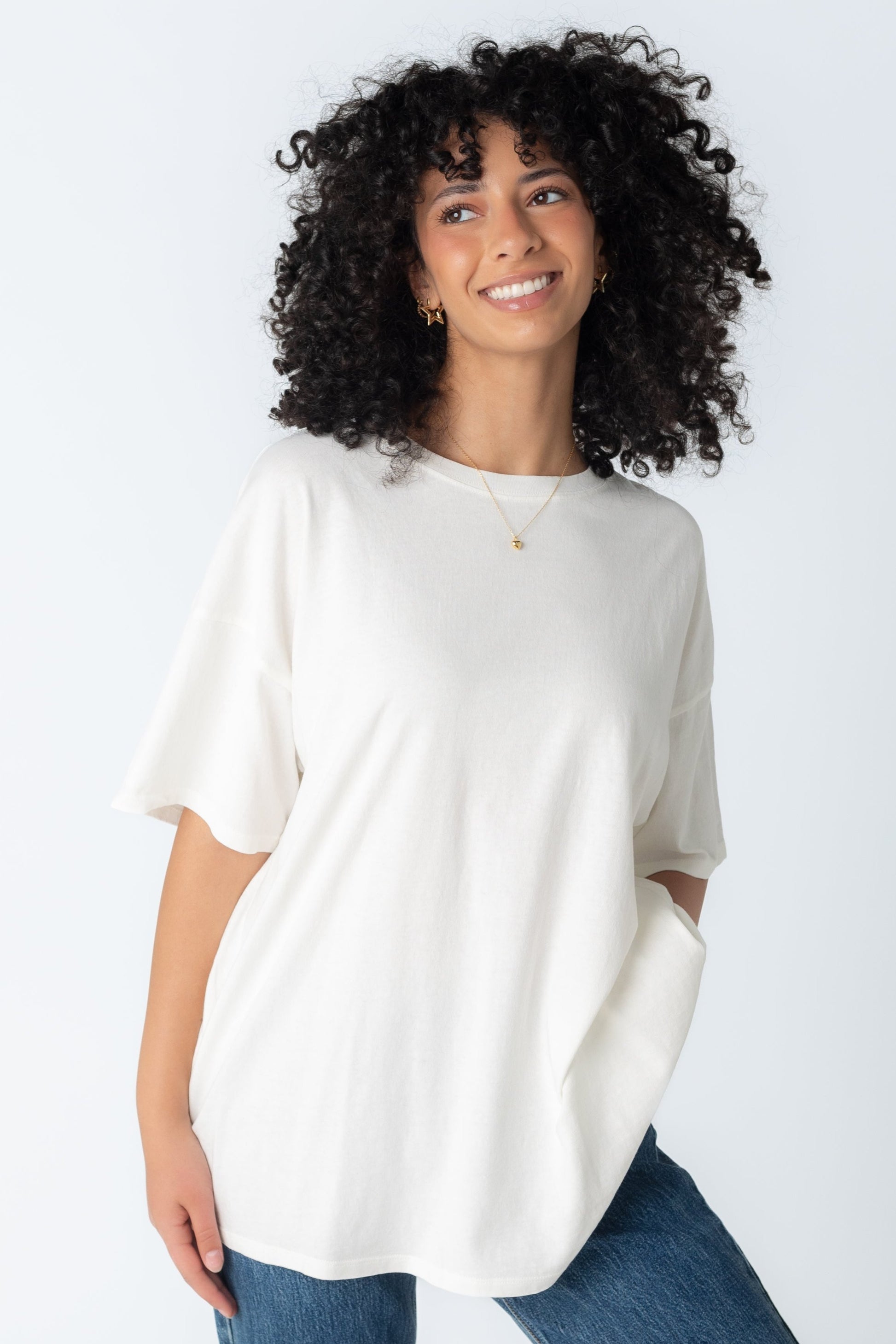 Modest off white loose fitting tee with half length sleeves and crew neckline