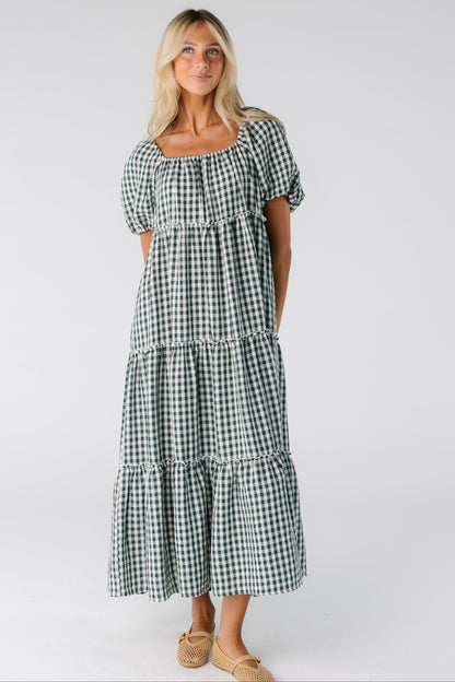 Woman wearing a green and white gingham midi dress with short sleeves