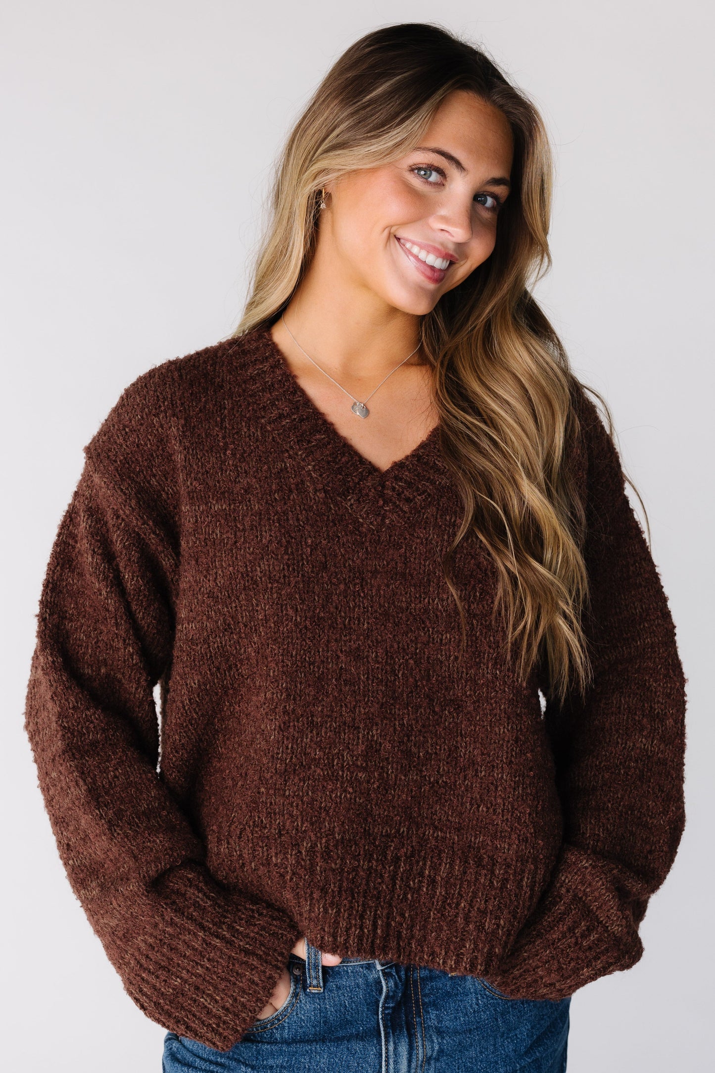 Woman wearing a bulky brown long sleeve sweater