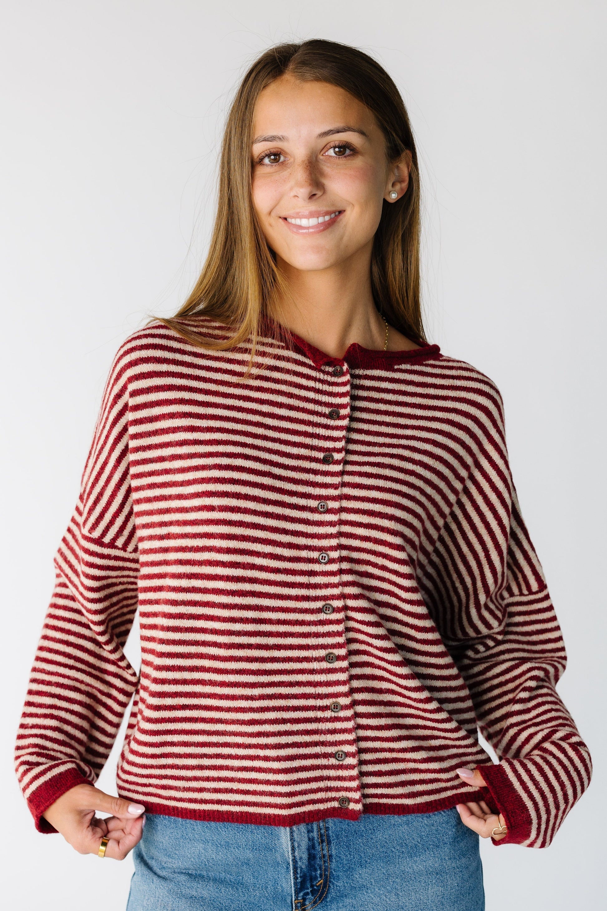 Woman wearing a modest dark red stripe cardigan with drop shoulders and long sleeves