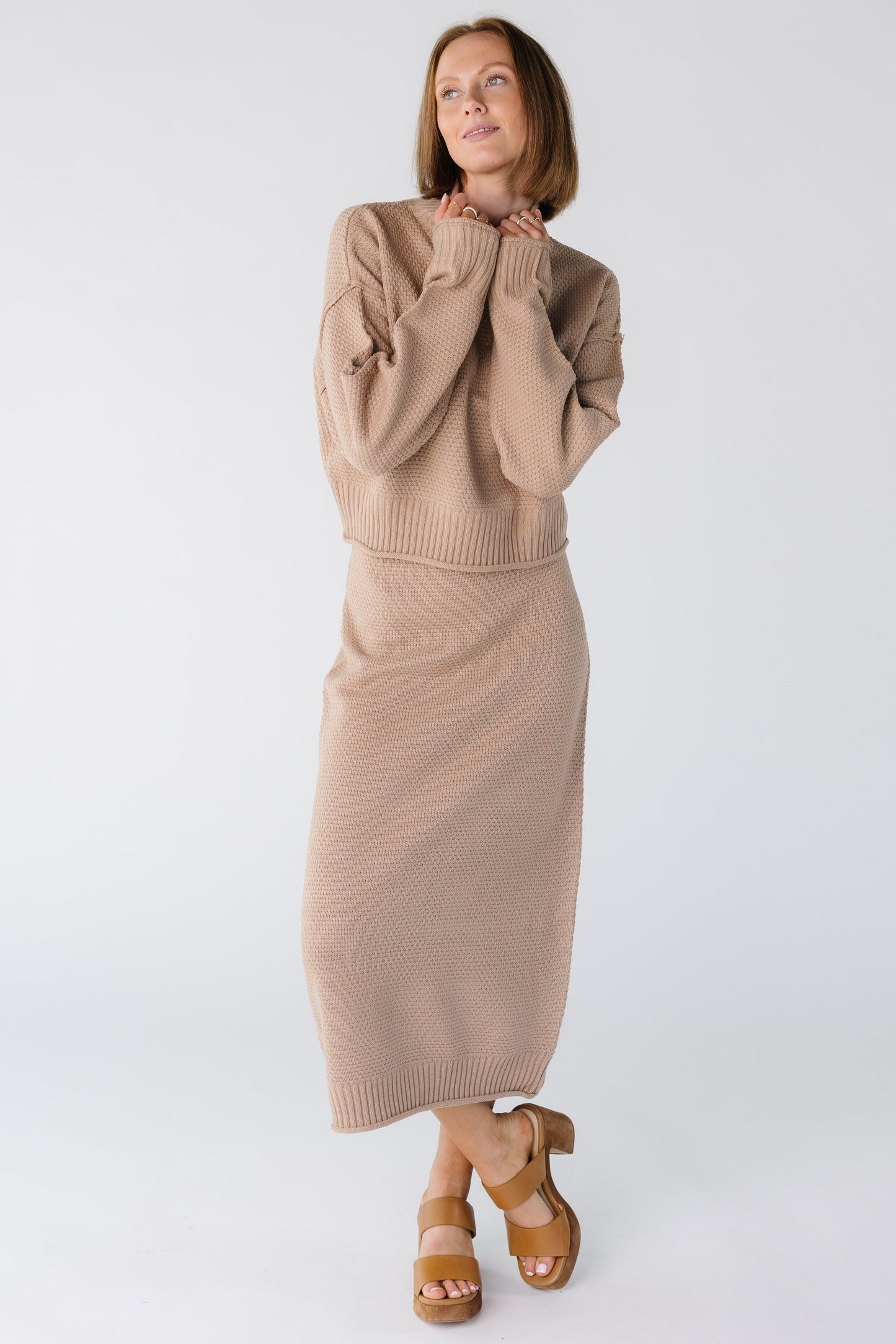Woman wearing a modest taupe sweater and skirt set