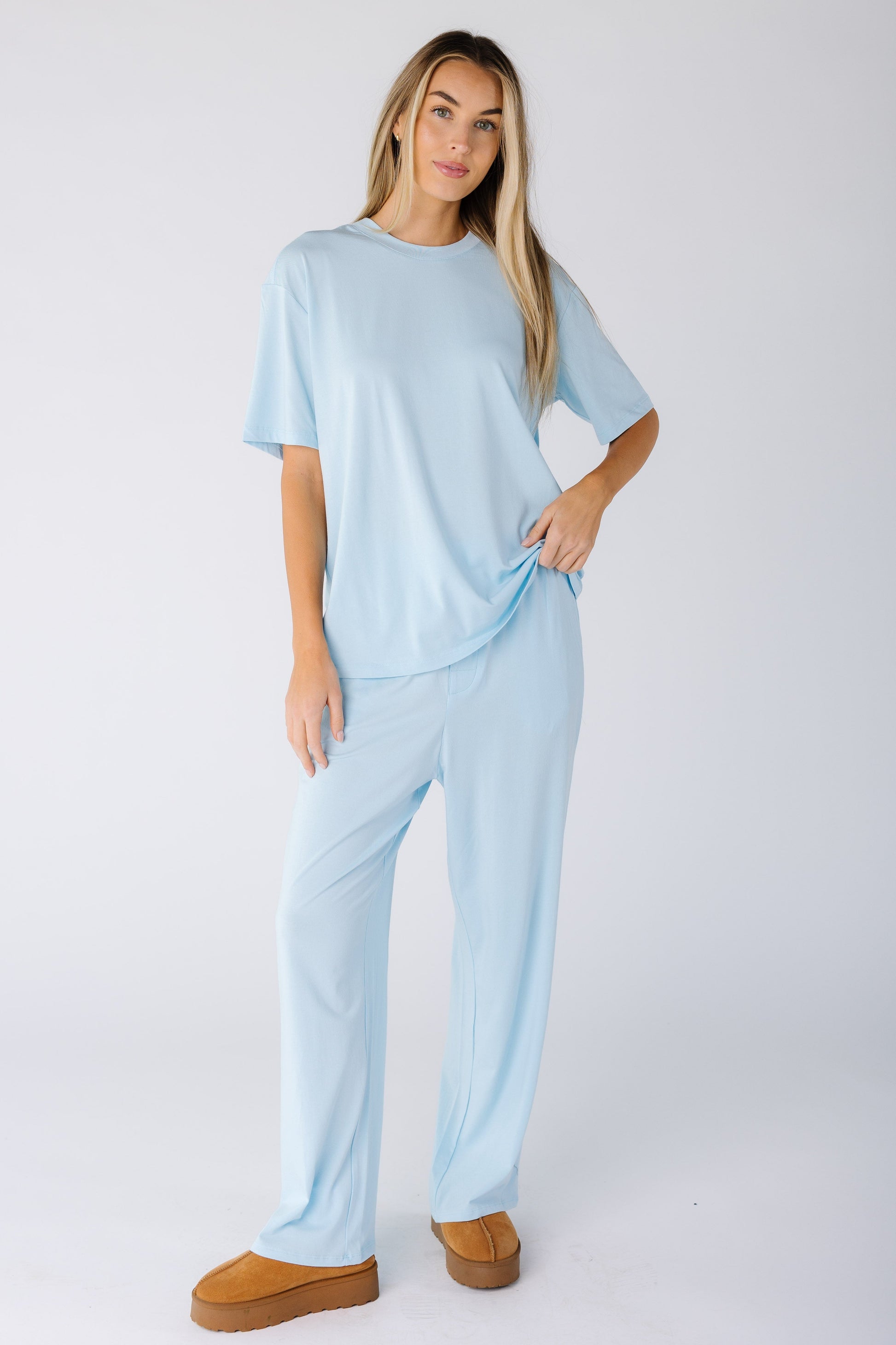 Woman wearing a modest lounge set with shorter sleeves and full length bottoms