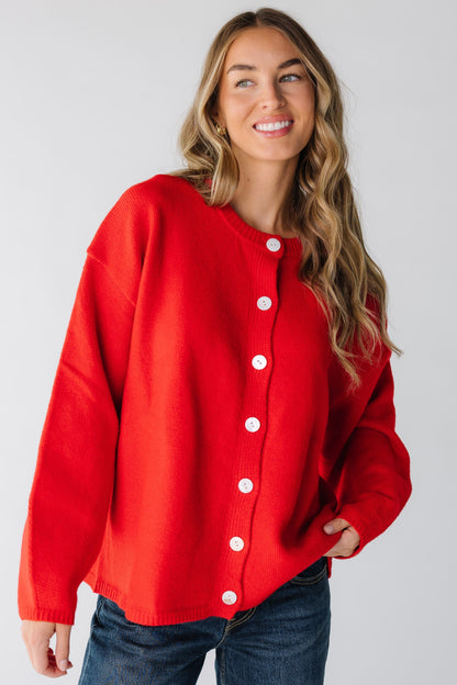 Woman wearing a red cardigan with loose long sleeves