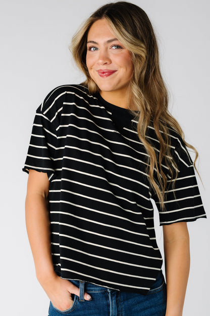 Woman wearing a modest short sleeve tee in black with white stripes with a crew neckline.