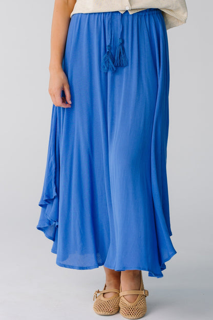 Blue curved hem skirt with tasseled belt