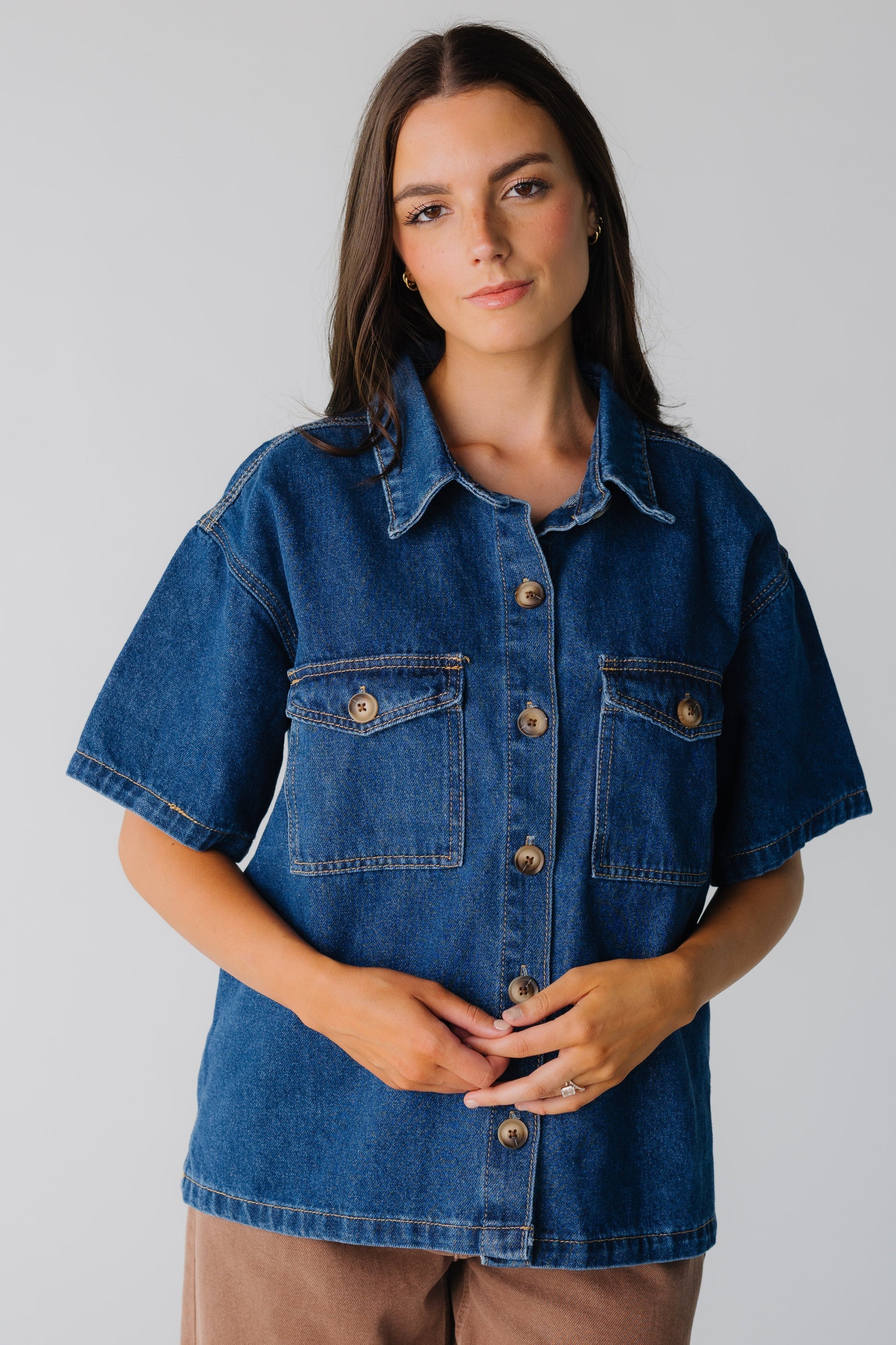 Dark denim women's button down shirt with contrasting buttons and front patch pockets