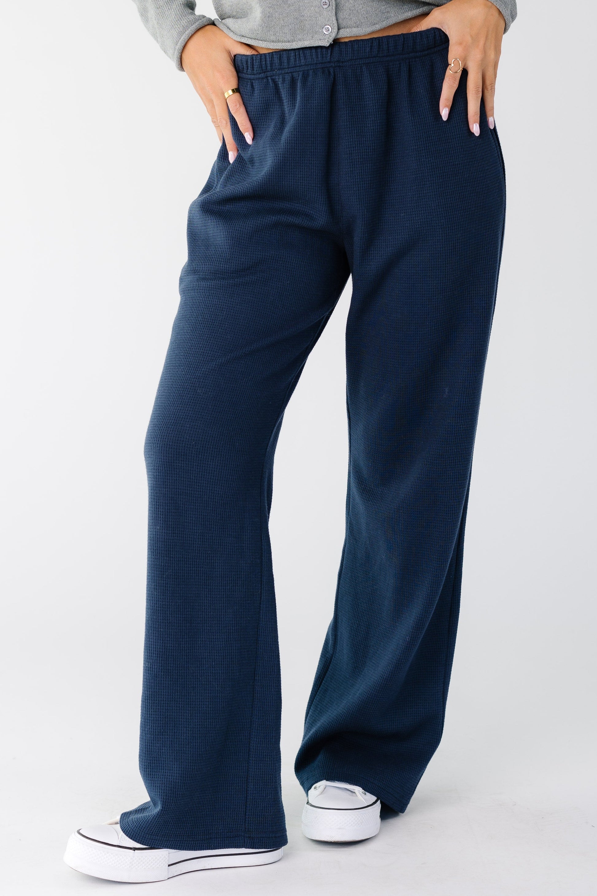 Woman wearing a pair of navy wide cut lounge pants
