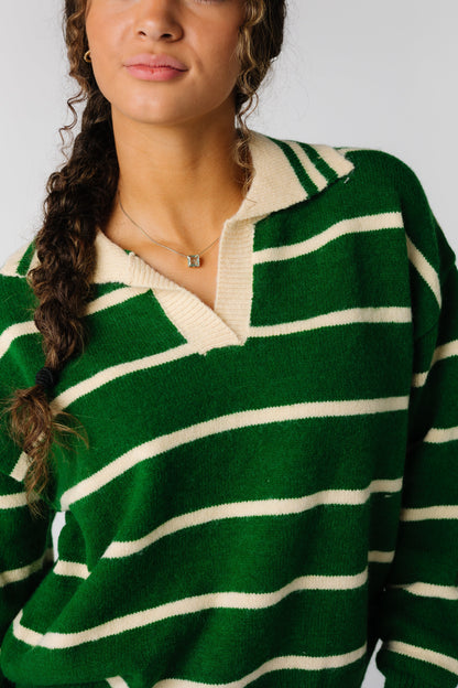 close view of green and cream stripe sweater with long sleeves