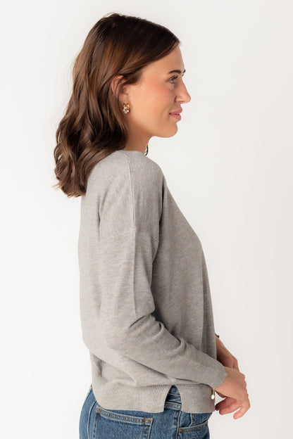 Side view of heather grey lightweight sweater with long sleeves