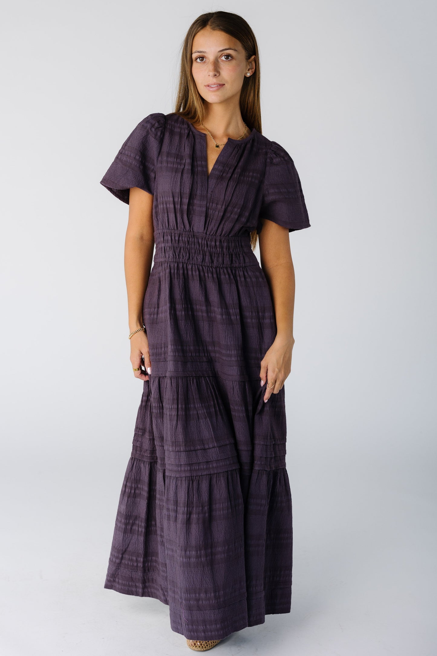 Woman wearing a modest plum maxi dress with short sleeves