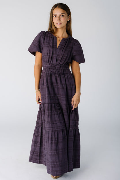 Woman wearing a modest plum maxi dress with short sleeves