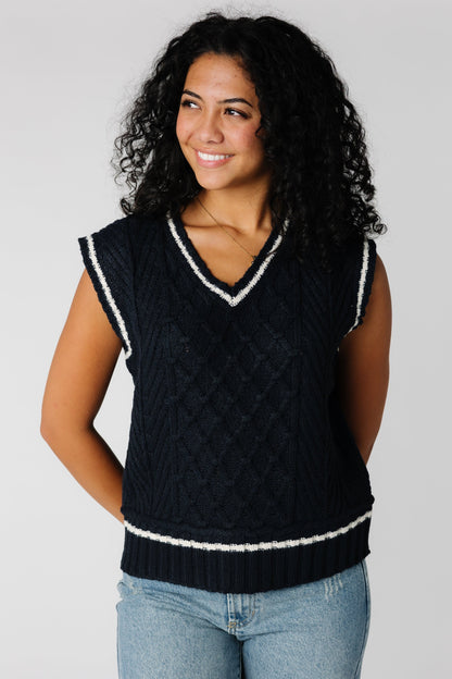 Navy cabled sweater vest with V-neckline with white contrasting stripe