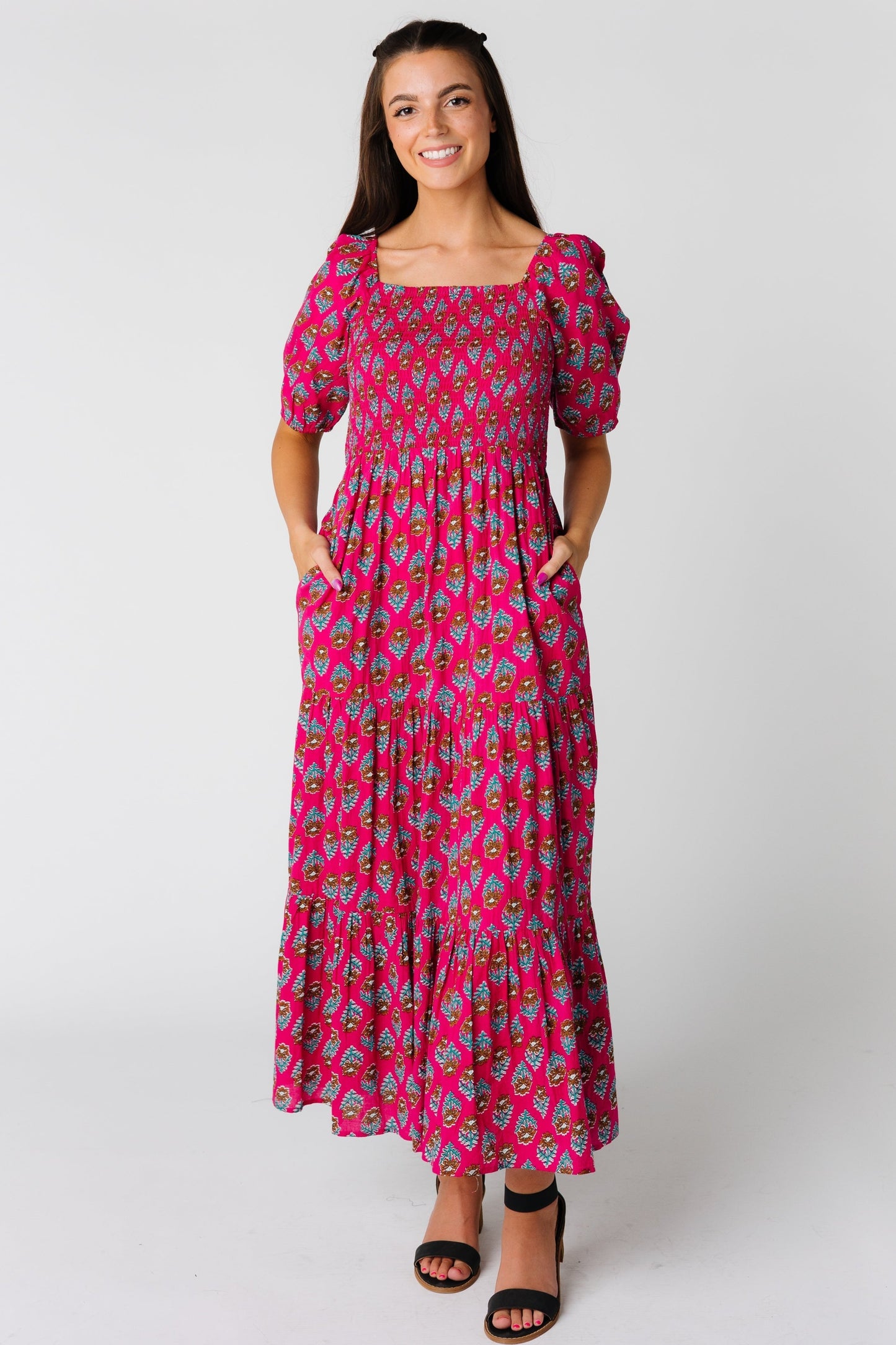 Modest pink midi dress with smocked bodice and gathered tiers