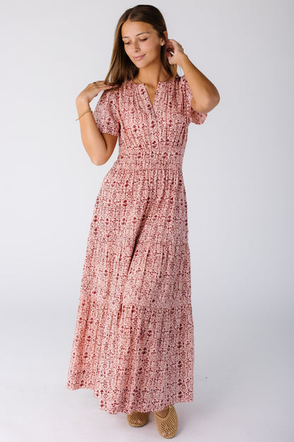 Woman wearing a modest pink print midi-maxi dress with short sleeves and V-neckline 