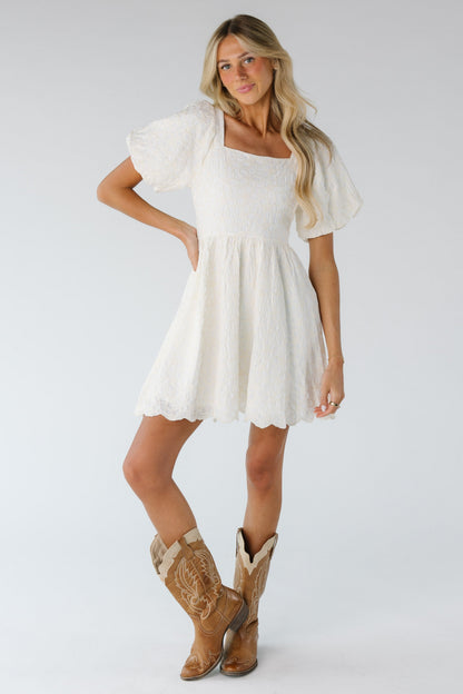 Cream on cream embroidered dress with lose fitting bodice and full skirt with scallop hem line